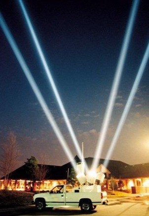 4-beam searchlight rental on a truck lighting up the night sky at a special event